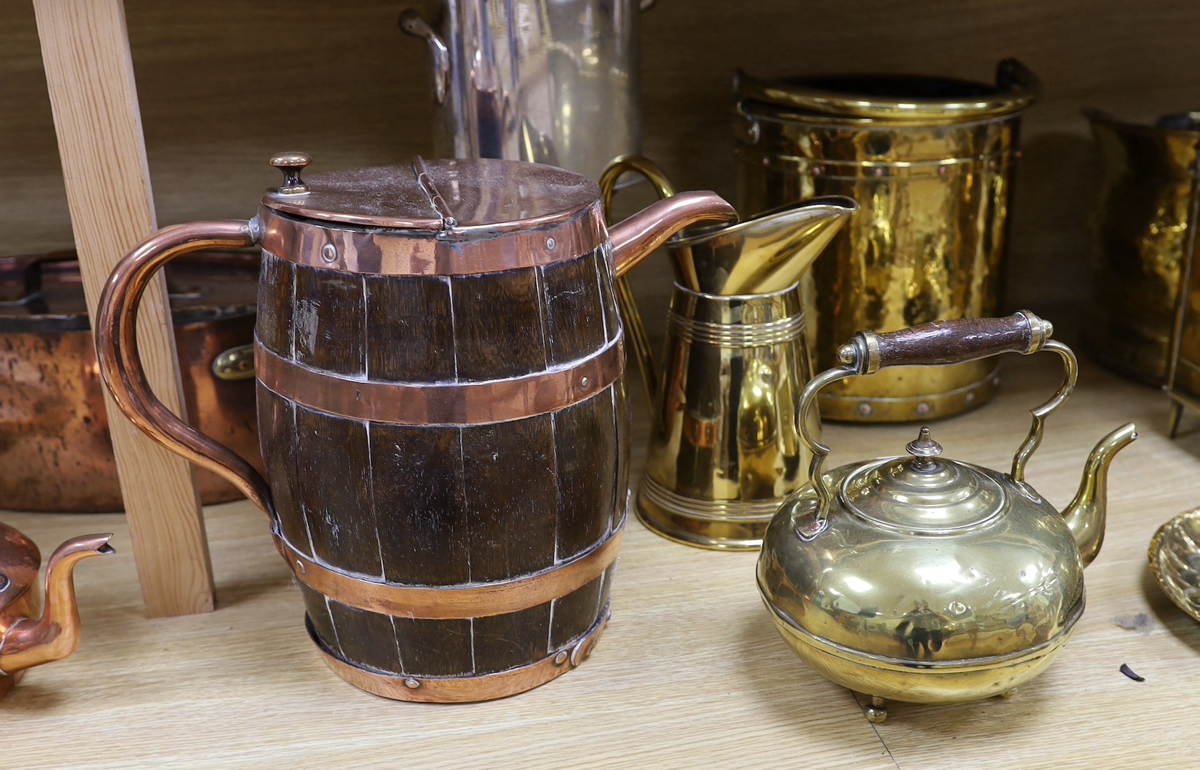 Sundry brass and copper, including a brass fireman’s helmet, a coal helmet, a staved and coopered wood and copper jug, a Victorian brass warming pan, a Victorian copper warming pan, a Victorian brass kettle etc.